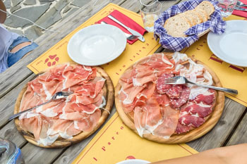Cold Cuts: Parma ham and salami in a refuge Lagdei in the 100 lakes park, Italy