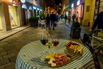 Local Italian aperitif: wine, cheese and meat cut, Parma, Italy